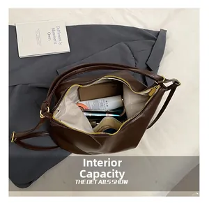 Detail view of the large capacity interior of this vintage brown faux leather tote bag