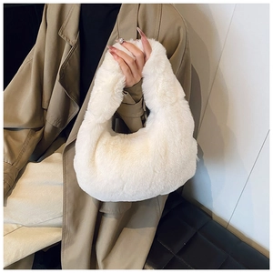 Close-up of soft white faux fur texture on a stylish plush dumpling handbag for women