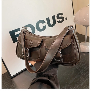 Detail of dark coffee shoulder bag with silver buckles and retro biker style pockets