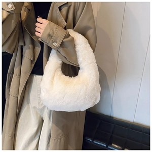 Detail of soft white faux fur plush handbag with a smooth round handle for winter style