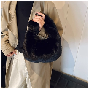 Close-up of black fluffy plush handbag featuring high-quality faux fur for autumn winter