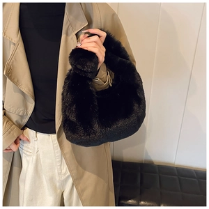 Detail of soft black faux fur handbag paired with a classic khaki autumn trench coat