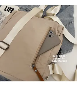 Back view of khaki nylon backpack showing a hidden zipper pocket for secure phone storage