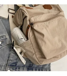 Detail view of the backpack side pocket holding a folding umbrella for storage convenience