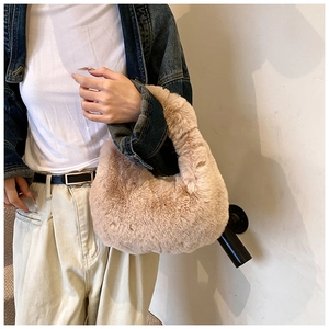 Detail of soft faux fur dumpling handbag in light brown for autumn and winter outfits