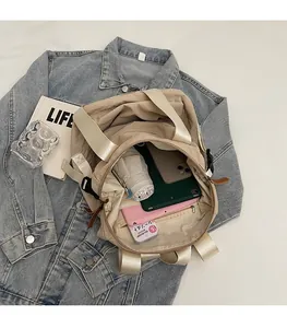 Internal view of large khaki tote showing storage capacity for laptop and daily items
