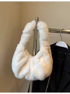 Plush faux fur cloud crossbody bag in cream white with a gold chain strap for winter