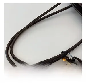 Detail of brown leather tote handles with vintage key and tennis racket pendants