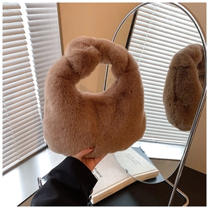 Detail of khaki plush dumpling bag featuring a soft knot handle and cozy faux fur texture