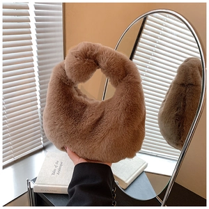 Detail of soft brown faux fur handbag with a unique single knot handle design