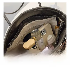 Detailed view of tote bag interior featuring large capacity and a smooth zipper pocket