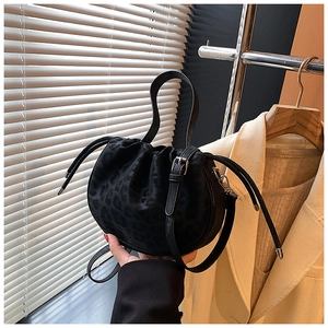 Detail der schwarzen Beuteltasche mit Leopardenmuster, Trageriemen und Kordelzug-Design