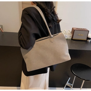 Detail of taupe suede tote bag showing soft texture and large capacity on shoulder