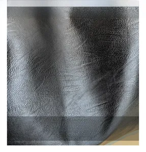 Macro shot of high-quality black faux leather texture with natural lychee grain for tote bag