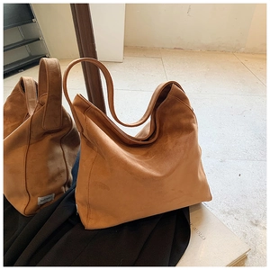 Close-up of a camel leopard tote bag made of premium matte suede with soft pleats