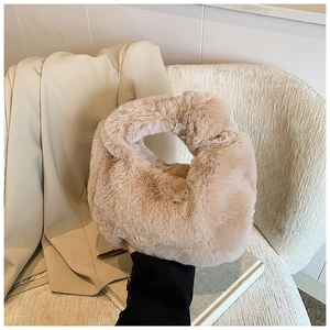 Detailed view of the soft faux fur texture on this plush apricot handbag for winter