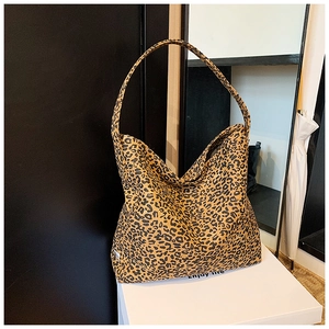 Detail of vintage leopard print canvas tote bag with thick texture and handle