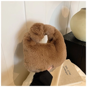 Detail showing the plush brown faux fur texture and integrated handle of this tote bag
