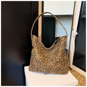 Detailed view of the vintage leopard print tote bag with wide shoulder strap on a display