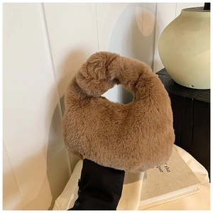 Detail of soft plush knot handle and fluffy texture on this camel hobo dumpling bag