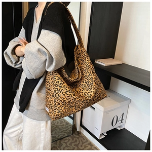 Detailed macro view of high-capacity leopard print tote bag with soft canvas texture