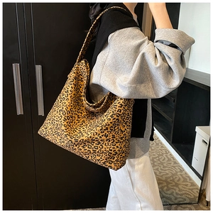 Detail view of large leopard print tote bag styled with casual autumn streetwear