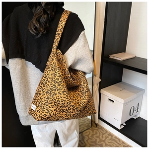 Detail of large leopard print tote bag with Chic Cat woven label and canvas texture
