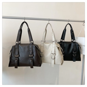 Detailed display of large retro tote bags in dark brown, beige, and black textured leather