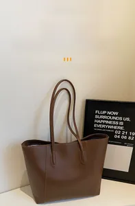 Detailed close-up of dark brown large capacity tote bag featuring premium leather texture
