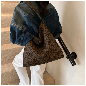 Detail showing high-capacity leopard print tote bag texture and soft fabric material