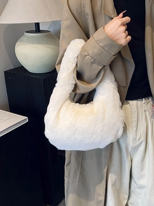 Chic white faux fur dumpling handbag for women in a cozy autumn winter street style