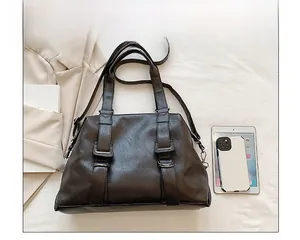 Brown vintage tote bag detail showing interior capacity with tablet and phone