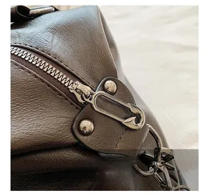 Macro view of dark brown leather texture with unique pin-shaped metal zipper and rivets