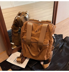 Detailed view of caramel nylon backpack with waterproof fabric and adjustable side buckles