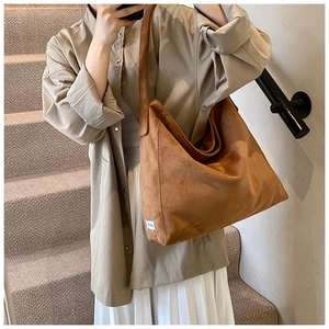 Detail of brown suede Hobo bag with stylish square woven label and large capacity