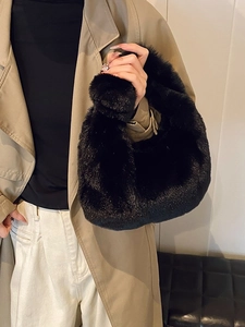Chic black faux fur dumpling handbag with plush texture for elegant winter fashion styling