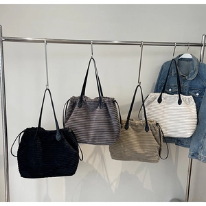 Corduroy tote bags in four colors with leather straps and drawstring closure detail