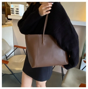 Brown leather tote bag for women showing large capacity and minimalist design