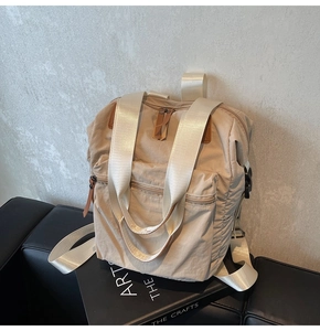 Macro detail of beige nylon backpack with durable crinkled fabric and wide handles