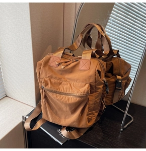 Detailed close-up of brown large-capacity backpack with premium leather accents and texture