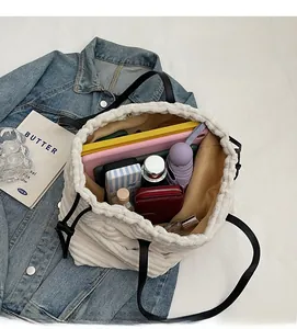 Spacious interior of white corduroy tote bag holding tablet, umbrella, and accessories