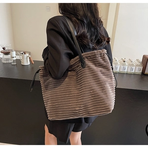 Detail showing high-quality brown corduroy texture and durable black shoulder straps