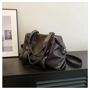 Detail view of large dark brown tote bag with premium synthetic leather and metal buckles