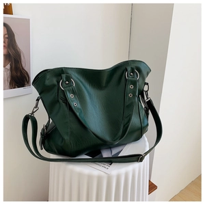 Detailed close-up of dark green PU leather tote bag with vintage silver ring hardware