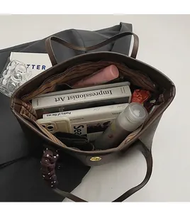 Top view of large capacity tote bag interior with multiple items showing spacious storage