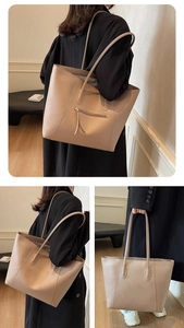 Detailed close-up showing the zipper pocket on the back of this beige large tote bag
