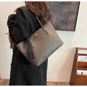 Deep brown lychee texture tote bag featuring a DM metal logo and stylish polka dot scarf