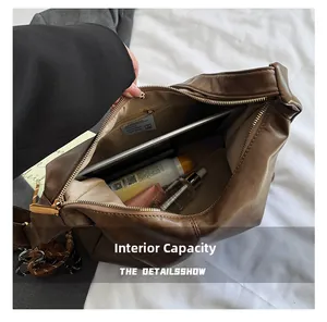 Internal capacity of the dark brown leather hobo bag showing space for tablet and makeup