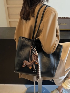 Vintage black leather tote bag with dachshund charm and shoulder straps for women