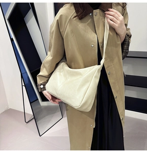 Close-up of cream hobo tote bag in soft PU leather featuring elegant vertical stitching